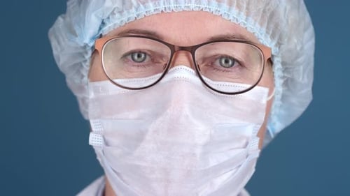 Female Doctor in Mask Looking at Camera