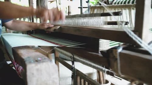 Craftsperson Weaving Colorful Textile on Wooden Loom