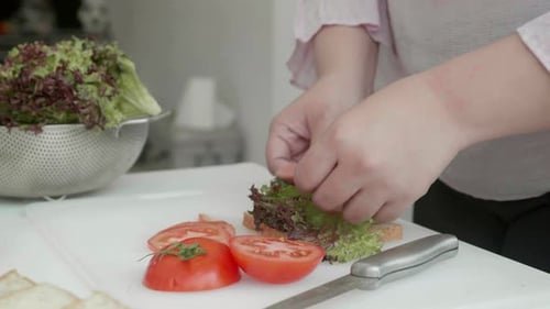 Woman Making Fresh Sandwich in Bright Kitchen