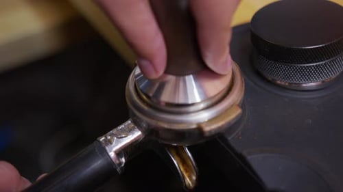 Tamping Coffee Grounds for Espresso Preparation