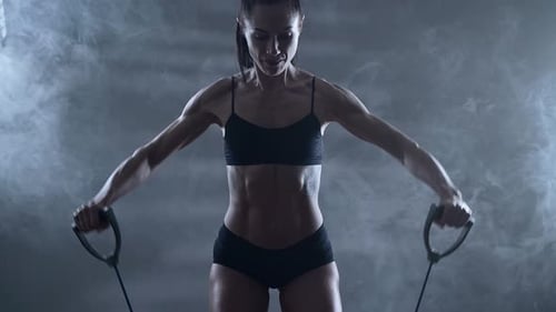 Strong Woman Exercises with Resistance Bands in Studio