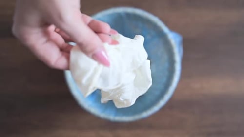 Close Up of Young Woman Throws Medical Gloves in the Trash