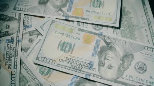 American 100 Dollar Banknotes are Rotating on the Table Close Up