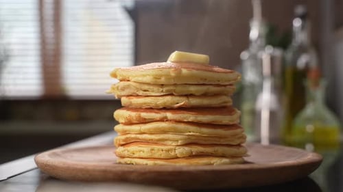Stack of Delicious Pancakes with Butter in Kitchen