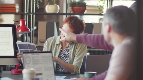 Businesswoman Discussing Project with Team at Office Meeting
