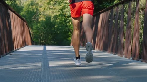 Slow Motion Fit Man Jogging on Bridge in the Morning