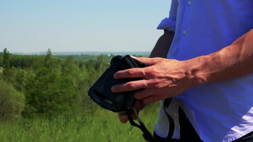 Man Examines VR Headset Outdoors