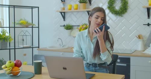 Woman Making Phone Call at Home Office. Focused Businesswoman Speaking on Smart Phone. Recording