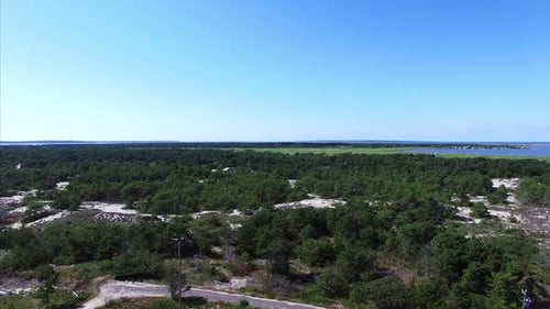 Aerial shot of a house in the forest near the beach