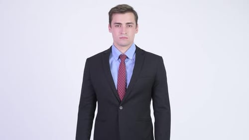 Young Adult Man in Suit Staring at Camera
