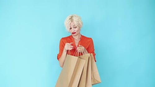 Woman Looking at Shopping Bags