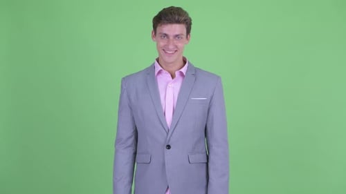 Happy Young Businessman in Suit Smiling