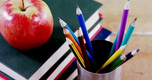 Red Apple and School Supplies on Table