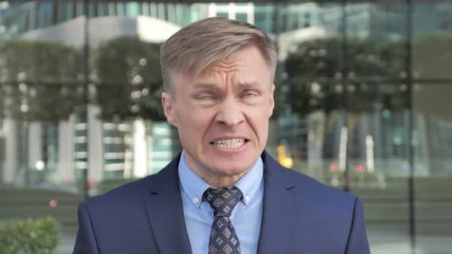 Distressed man close up shouting in suit