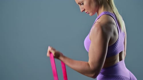 Woman Exercising Arms with Resistance Band