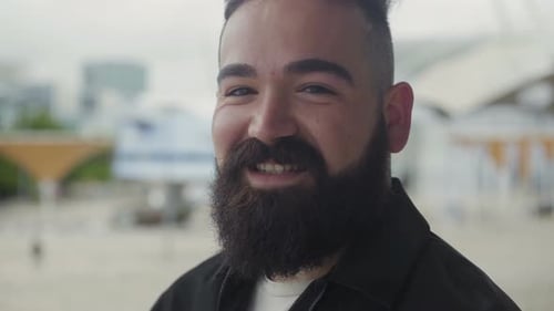 Bearded Man Smiling in Urban Setting