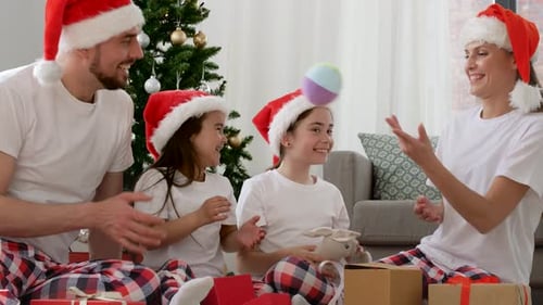 Happy Family Opening Christmas Gifts at Home