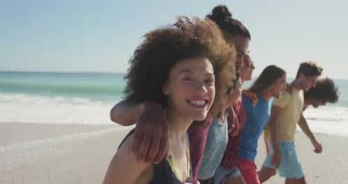 Diverse Friends Walking on a Sandy Beach Together