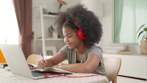 Teen Studying with Laptop at Home