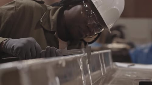 Female African Worker Using Caliper