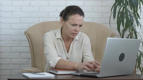 Stressed freelancer by computer.