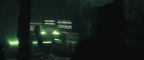 Person in Dark Room with Computer Screens