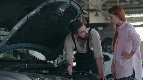 Auto Mechanic Explains Car Repair to Customer