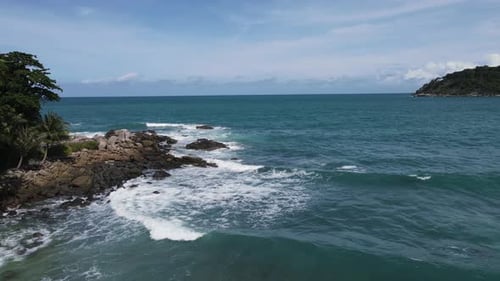 Drone top view of beautiful turquoise sea waves breaking on sandy coastline