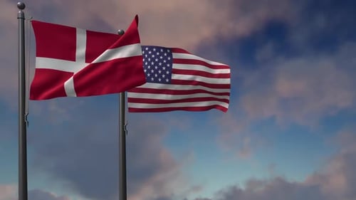 Danish and American Flags Waving on Flagpoles Against Blue Sky