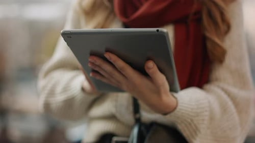 Woman Using Tablet Device in Urban Setting