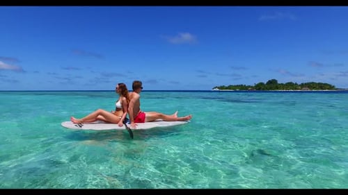 Two lovers in love on luxury shore beach time by shallow sea with white sand background of the Maldi