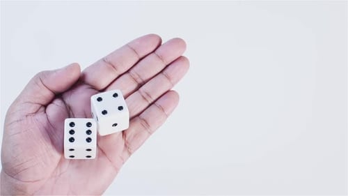 Hand Holding Dice in the Palm of Hand