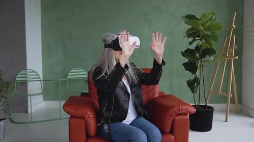 Adult Using VR Headset in Red Armchair