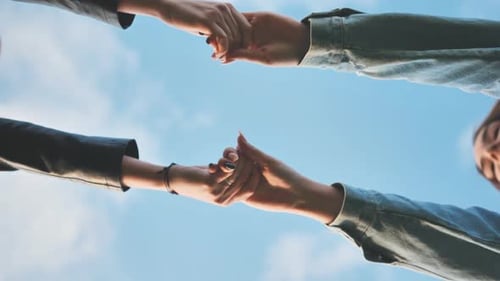 Women Holding Hands to the Sky