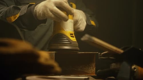 Worker polishing metal with grinder