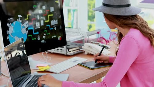 Young Woman Working at Desk with Graphic Tablet