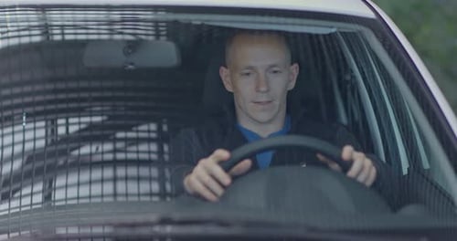 Man Sitting in a Car, Hands on Wheel