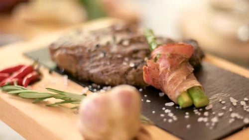 Steak with Seasoning Served with Asparagus and Garlic