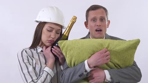Woman in Hardhat, Man with Pillow Look Startled