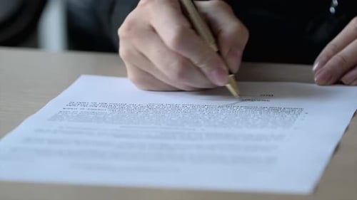 Signature on Contract by Pen in Female Hand