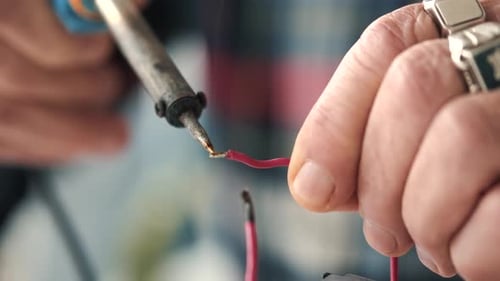 Soldering Iron Connects Wires in Close Up