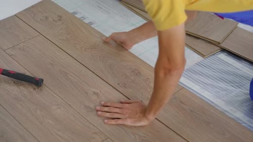 A Man Professional Laminate Installer Laying Laminate Wood