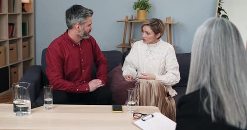 Crop View of Married Couple Discussing Family Problems While Sitting in Front of Psychologist