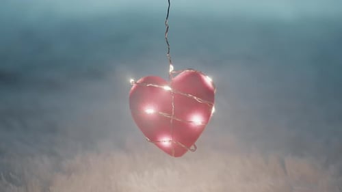 Illuminated Pink Heart Decoration in Smoky Background