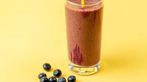Vibrant Smoothie with Fresh Blueberries and Yellow Straw