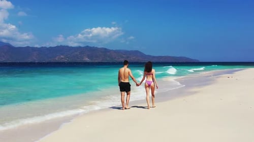 Man and lady in love on relaxing island beach journey by aqua blue water with white sandy background