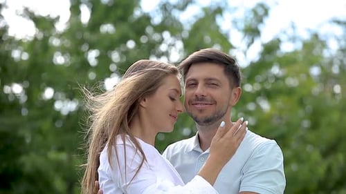 Affectionate Couple Sharing a Romantic Kiss Outdoors