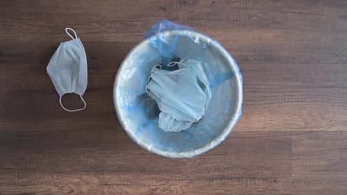 Discarded Face Masks in Trash Bin, Top Down