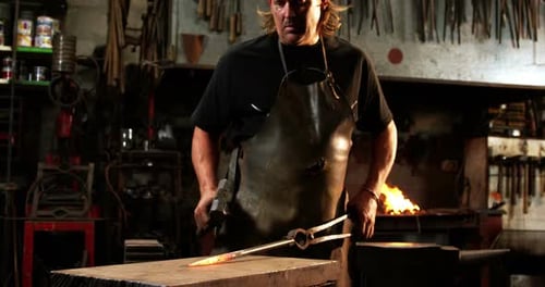 Blacksmith working on a iron rod