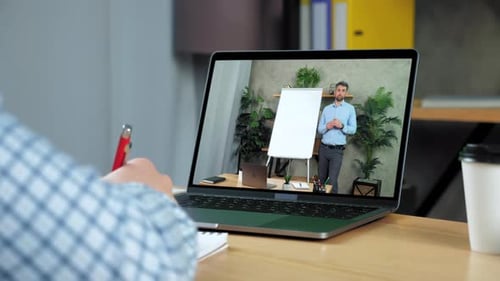 Businessman Writes in Notebook Studying Online Education Business Course Laptop